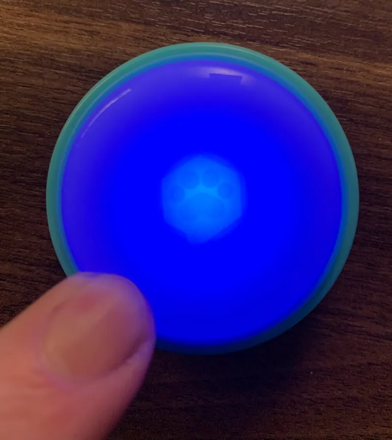 A Connect Button lit up blue while a finger presses it.